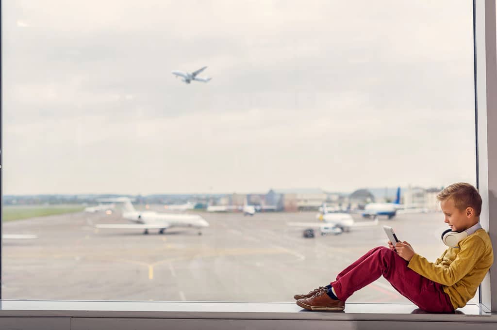 travel accessories boy with headphones at airport